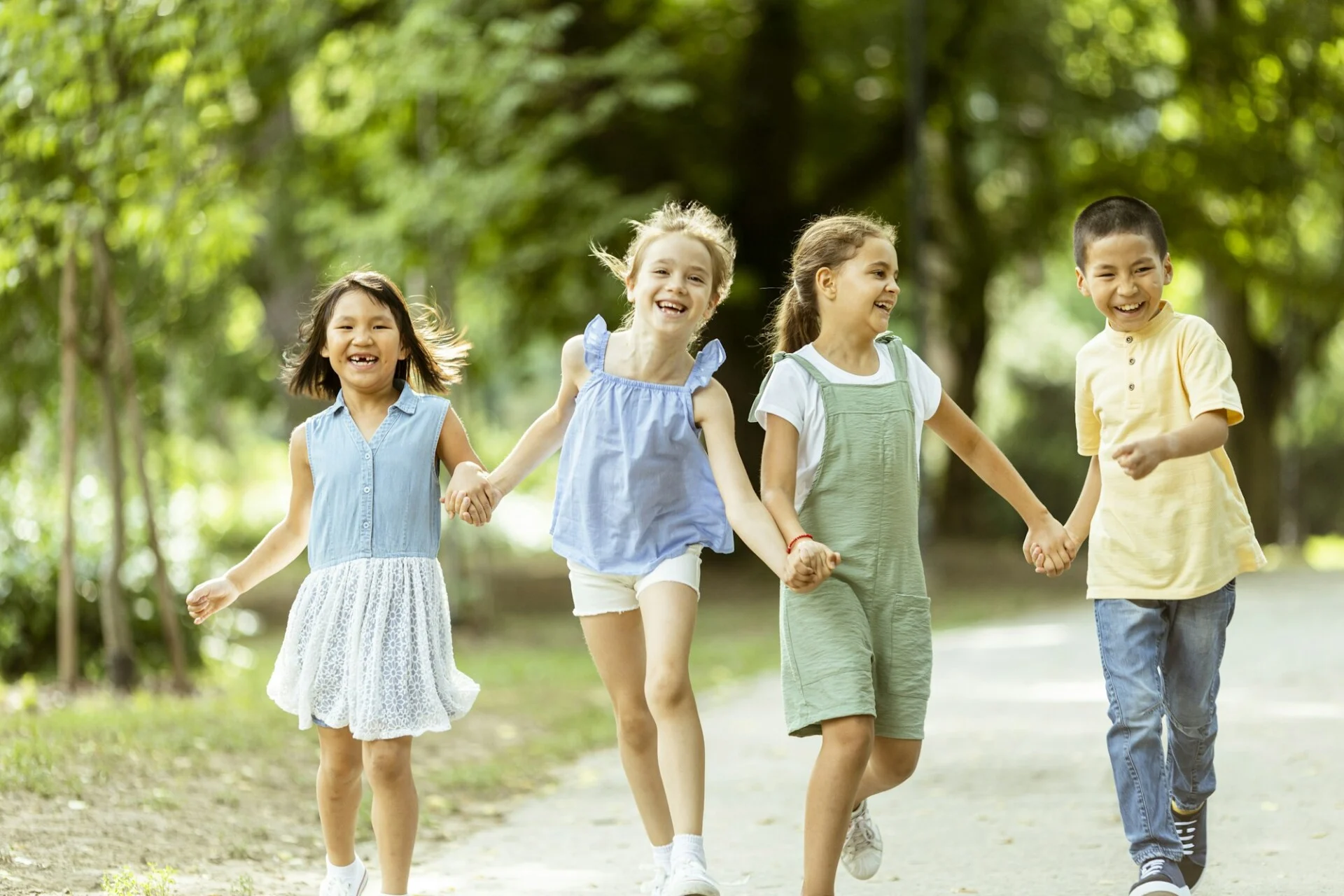 Group of asian and caucasian kids having fun in the park